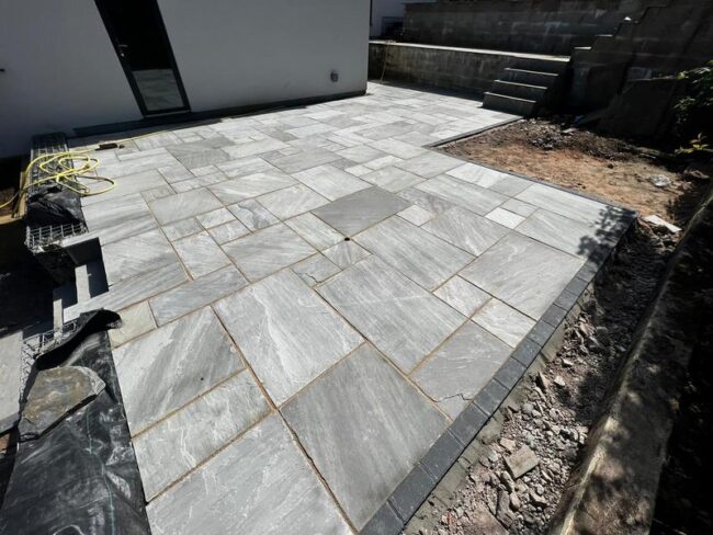 indian sandstone patio with railway sleeper flower bed 02
