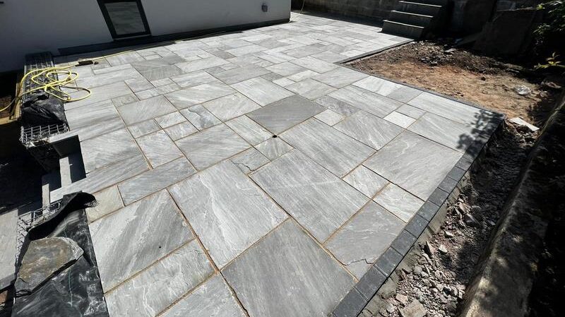 indian sandstone patio with railway sleeper flower bed 02