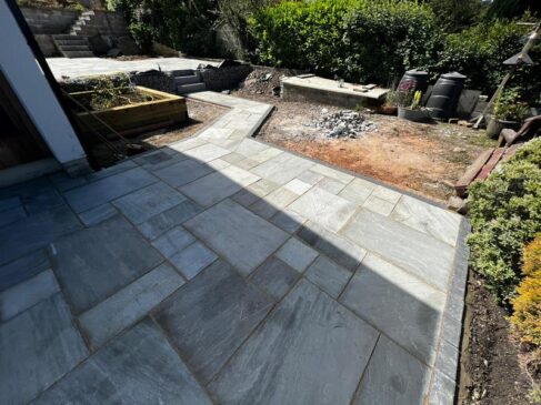 indian sandstone patio with railway sleeper flower bed 05