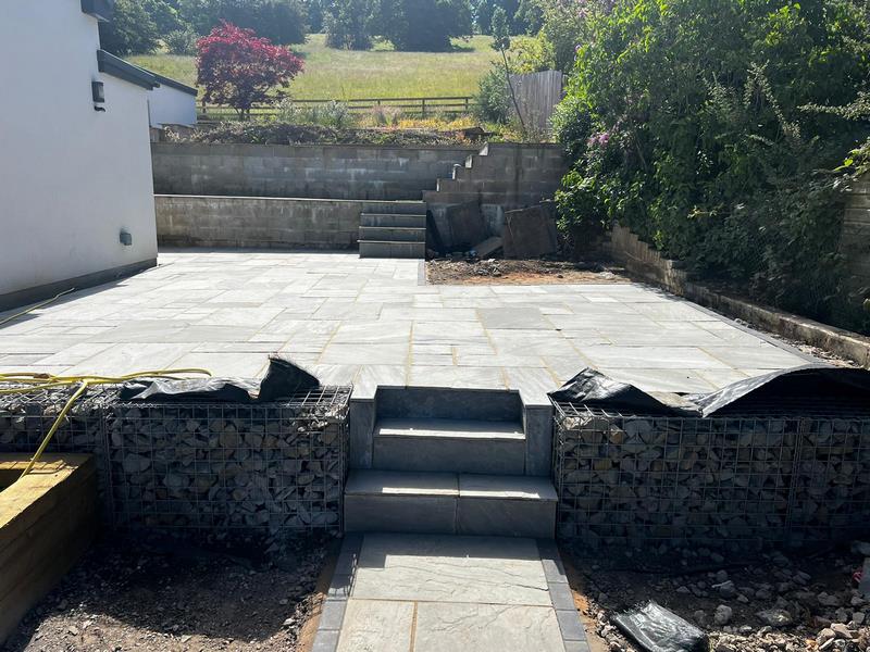 indian sandstone patio with railway sleeper flower bed 09